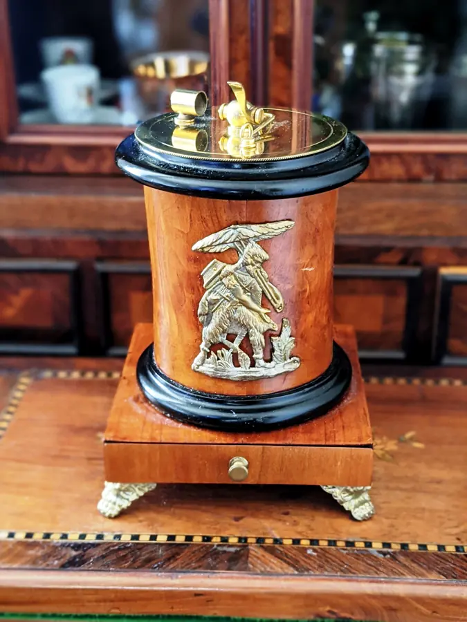 Early chemical table lighter with a wooden case and decorative brass figure