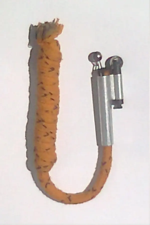 A vintage tinder lighter with a thick yellow cord and a small metal spark wheel